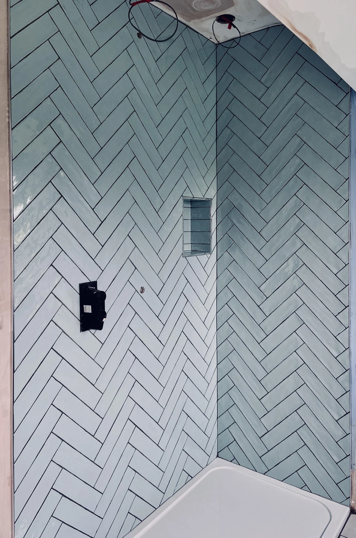 Herringbone shower wall tiling